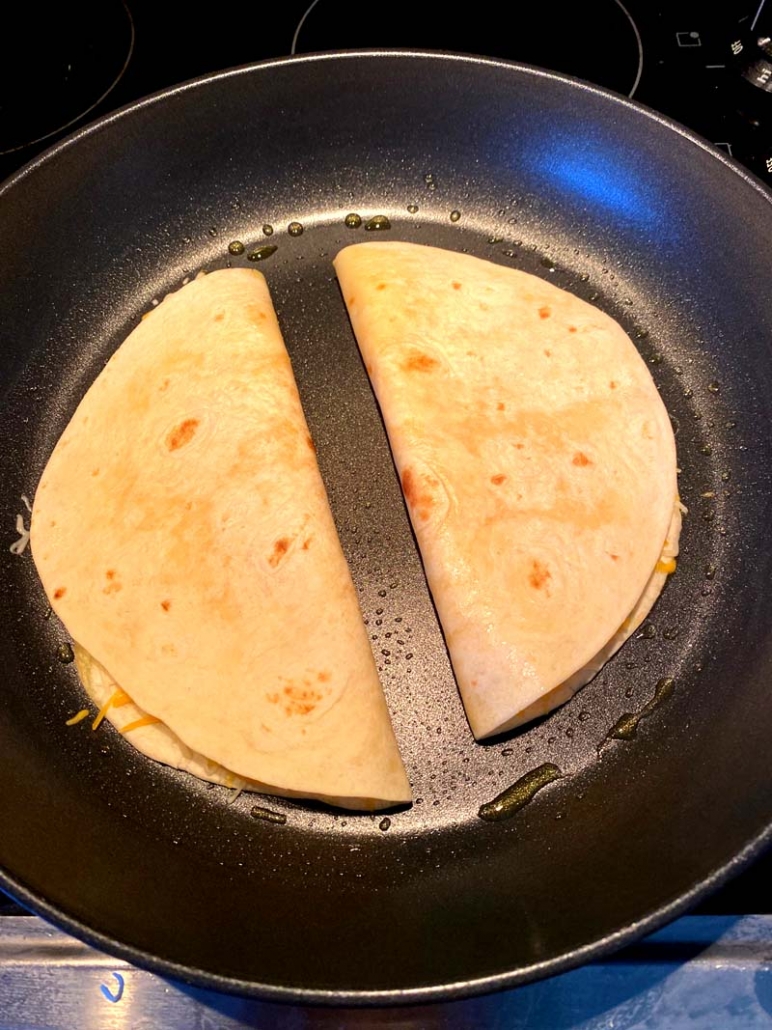 quesadillas cooking on a frying pan