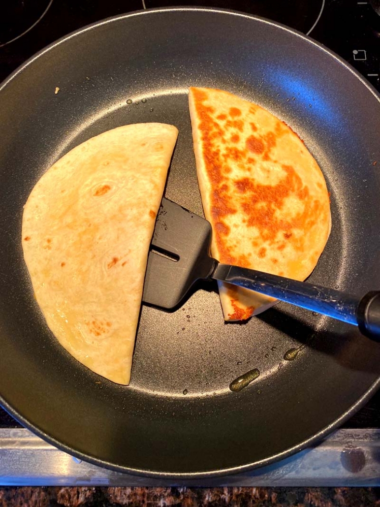 flipping cheese quesadilla