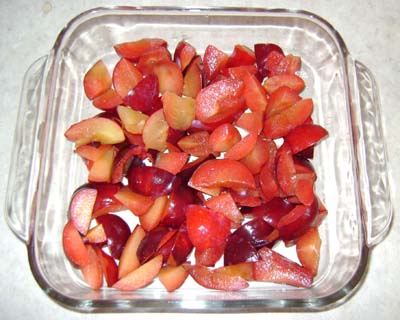 layer of plums on the bottom of the baking dish