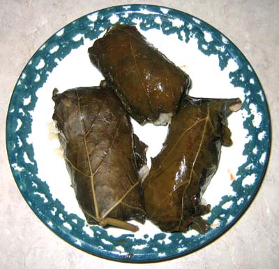 Top-view of three stuffed grape leaves.
