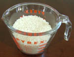 dry uncooked rice in a measuring cup