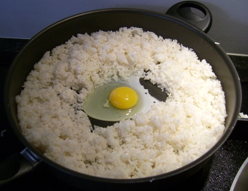 adding egg to fried rice