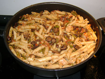 pasta chicken asparagus mushroom in a frying pan