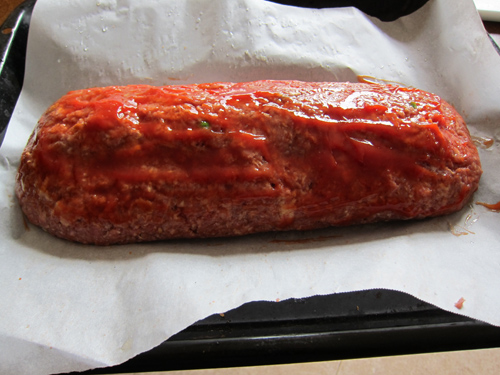 making stuffed meatloaf - brush with ketchup