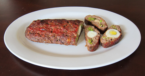 stuffed meatloaf with eggs, cheese and peas - sliced