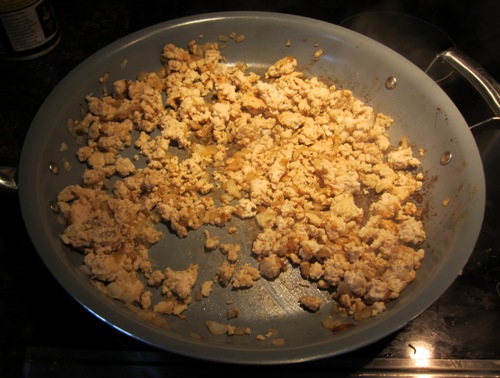 cooking onions and ground meat on a frying pan