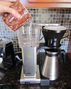 adding water to a coffee maker machine