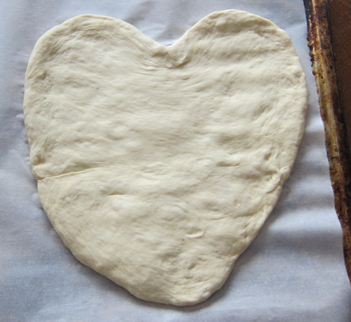 pizza dough rolled into a heart shape