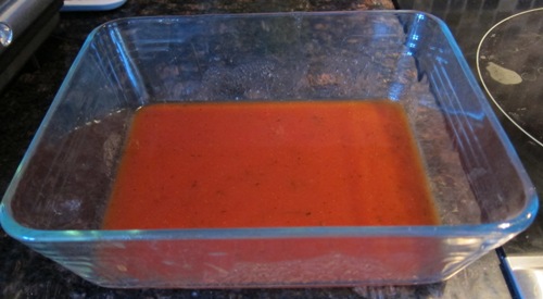 tomato sauce on the bottom of the baking dish