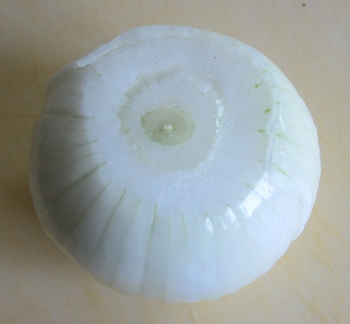 whole peeled onion ready for cutting
