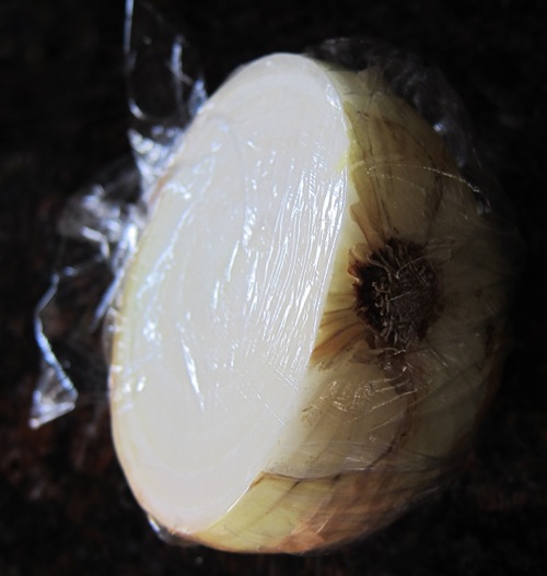 onion half wrapped in plastic wrap