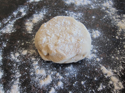 ball of dough sprinkled with flour