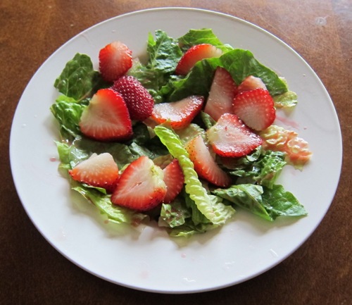 salad with lettuce and sliced strawberries