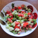 salad with chopped tomatoes, cucumbers, onion slices and cilantro