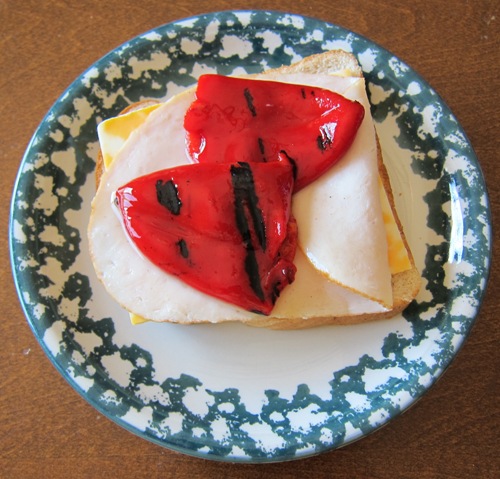 marinated sweet red bell peppers on a sandwich