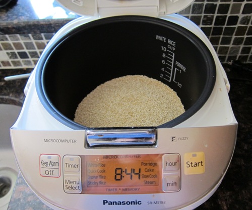 putting quinoa in a rice cooker