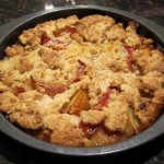 freshly baked plum pie in a baking dish