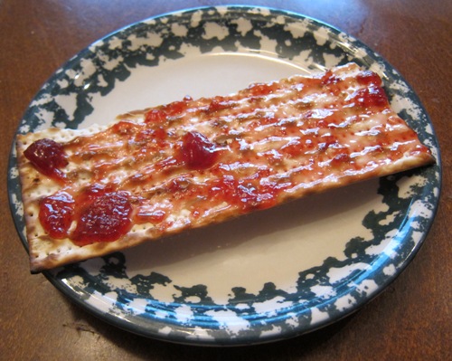 matzo cracker spread with jam on a plate