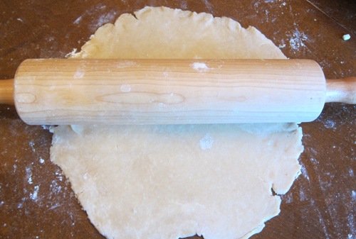 rolling the pie dough with a rolling pin