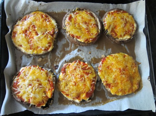 portobello mushroom pizzas on a baking sheet