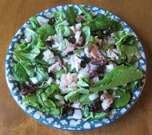 main dish salad with turkey, lettuce, olives and onions