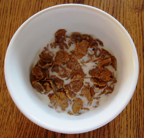 a bowl of Kashi Heart To Heart Oat Flakes And Blueberry Clusters Cereal with milk