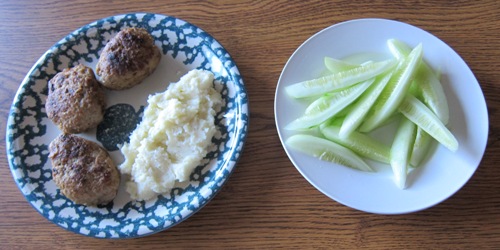 Russian Meat Patties (Kotlety) With Mashed Potatoes And Cucumber Spears For Dinner