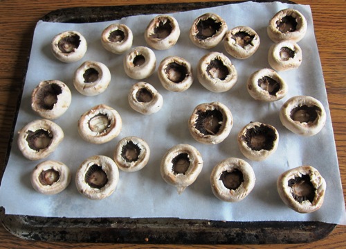 mushroom caps on a baking sheet