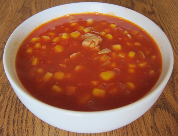 corn, chicken and tomato soup in a bowl