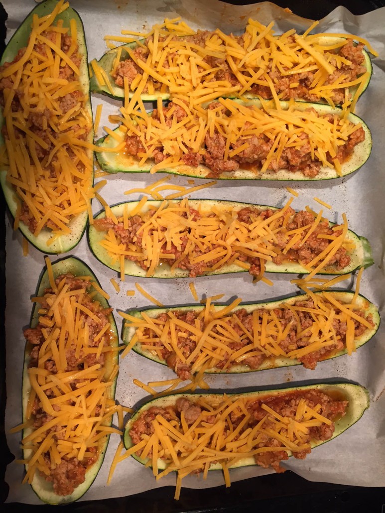 Sprinkle stuffed zucchini boats with shredded cheese