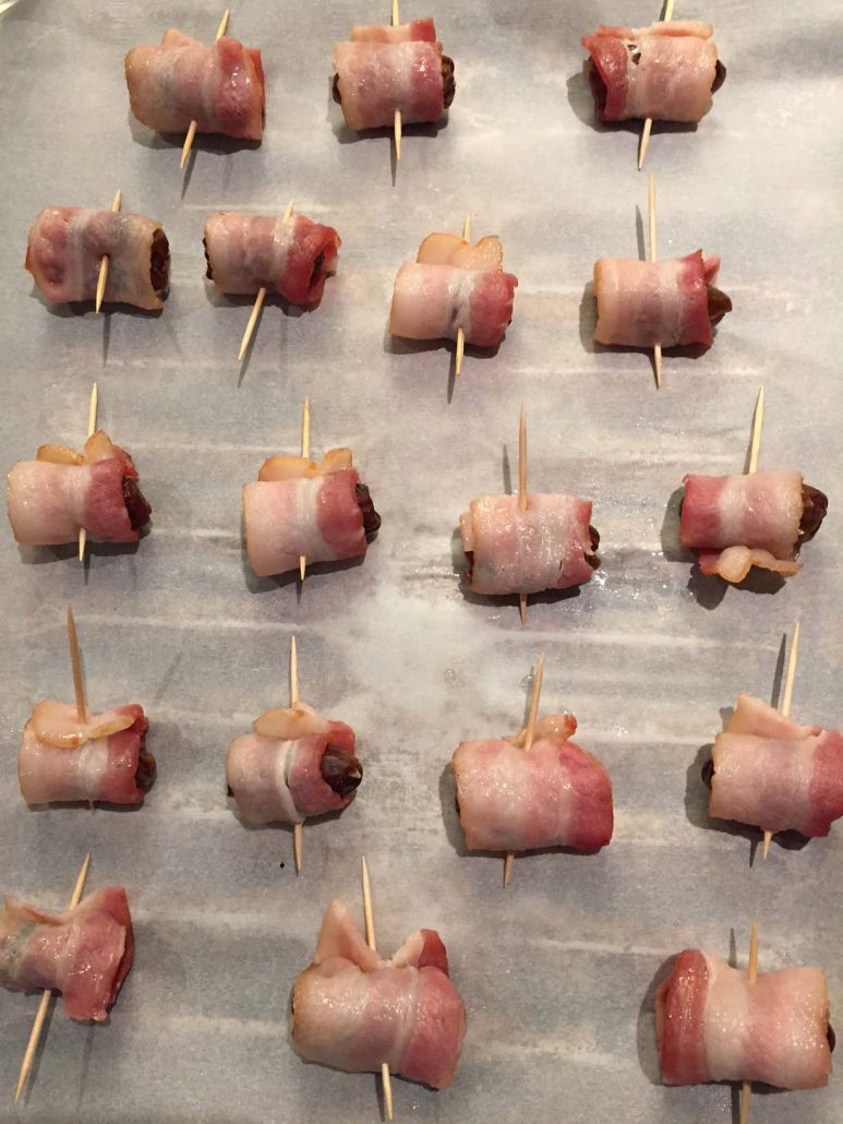 Bacon Wrapped Dates On A Baking Sheet