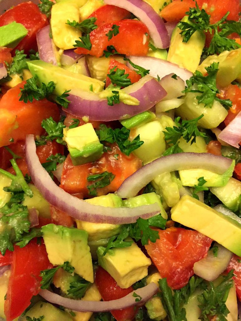 Tomato cucumber onion salad with avocado