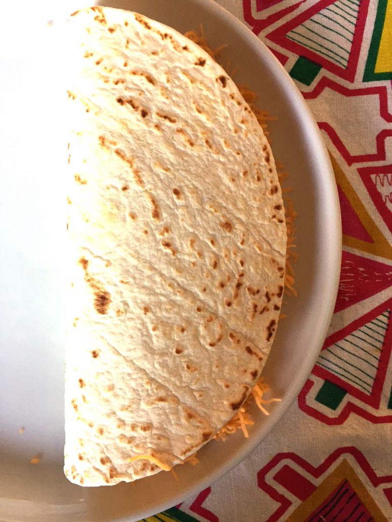 Fold tortilla in half to assemble quesadilla