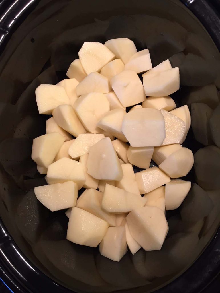 Peeled and quartered potatoes in a crockpot