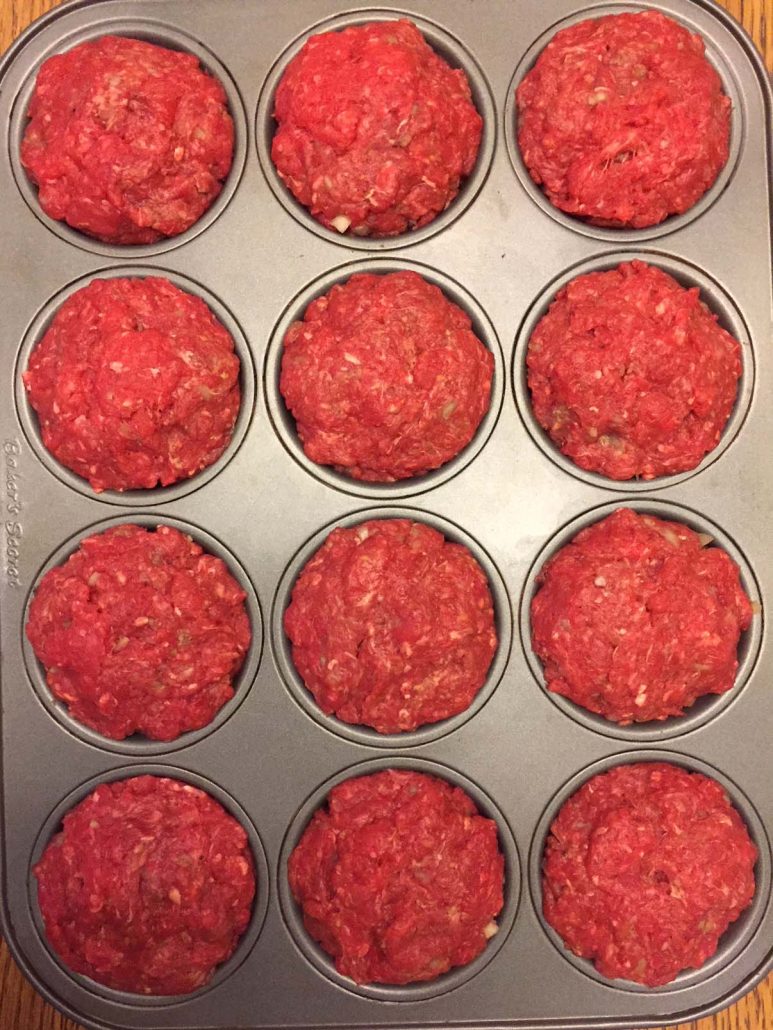 Meatloaf mixture in a muffin pan