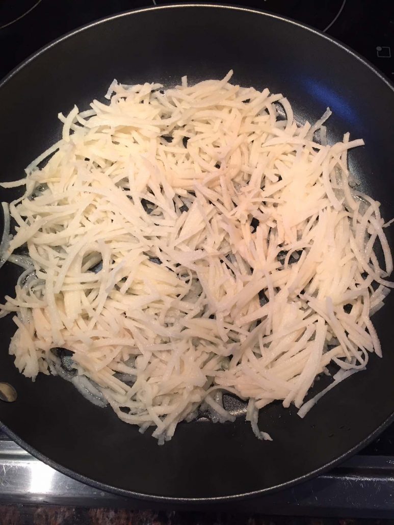 Shredded Potatoes On A Frying Pan