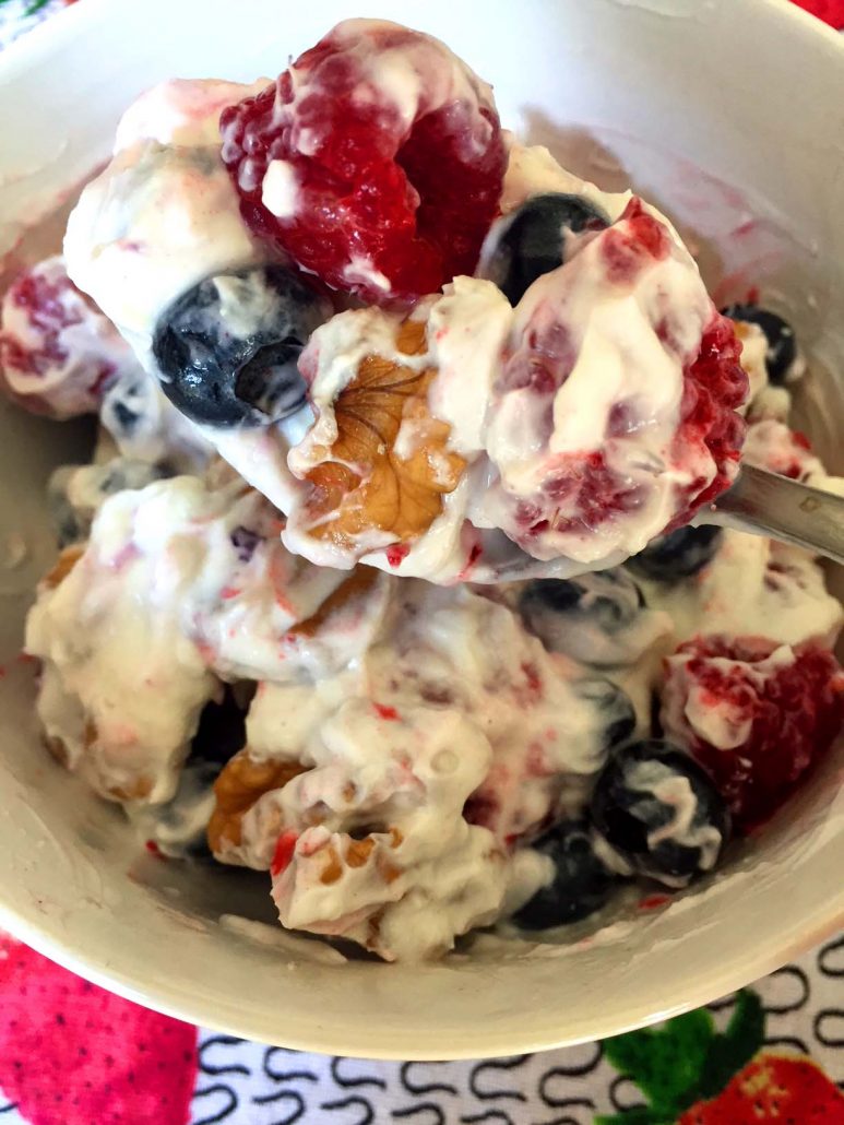 Low-carb yogurt bowl with blueberries raspberries and walnuts