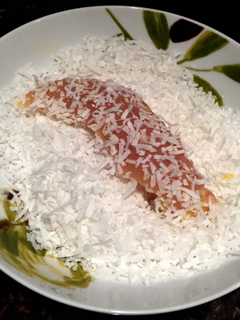 Chicken tender dipped in unsweetened coconut flakes