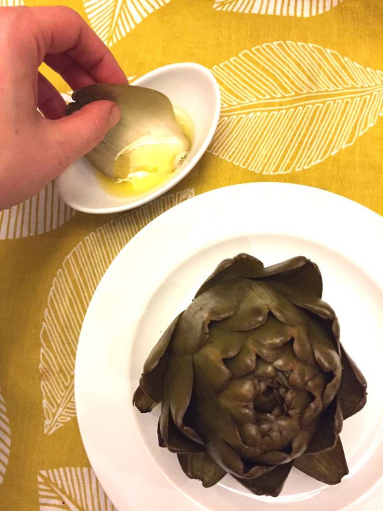 Eating an artichoke dipping in butter