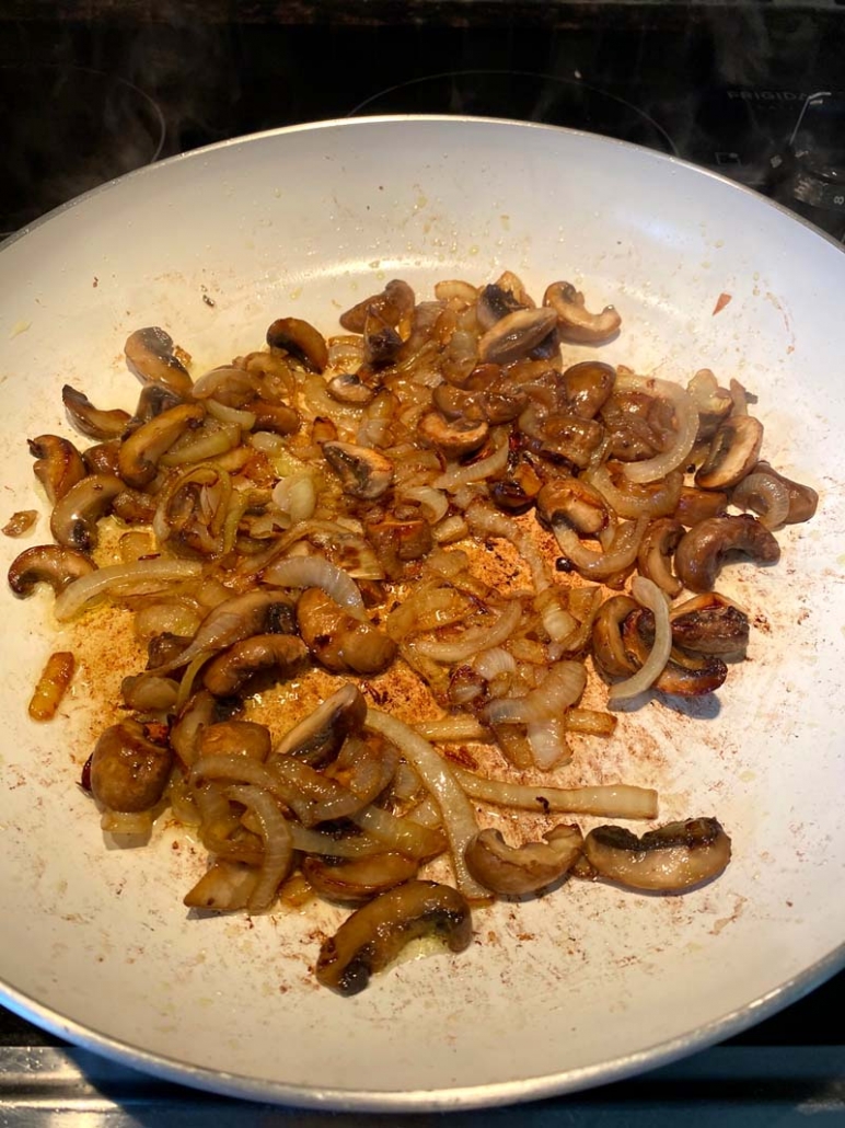 mushrooms and onions on a frying pan