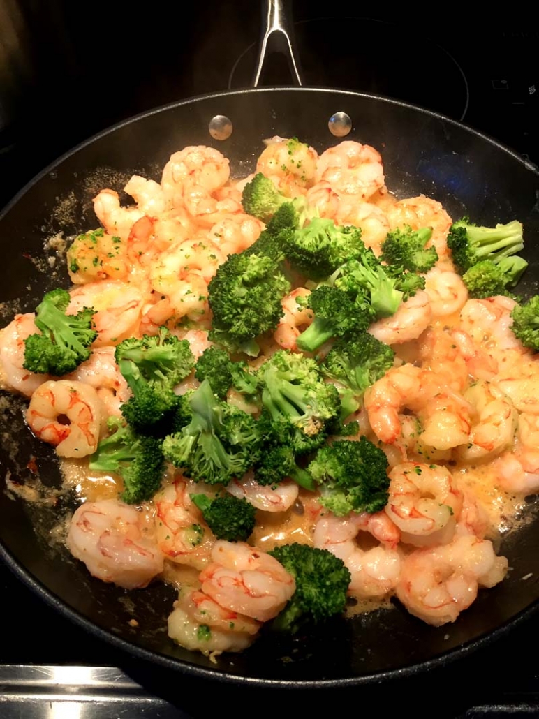 shrimp broccoli butter on a frying pan