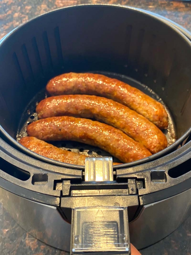 cooked sausages in air fryer basket 