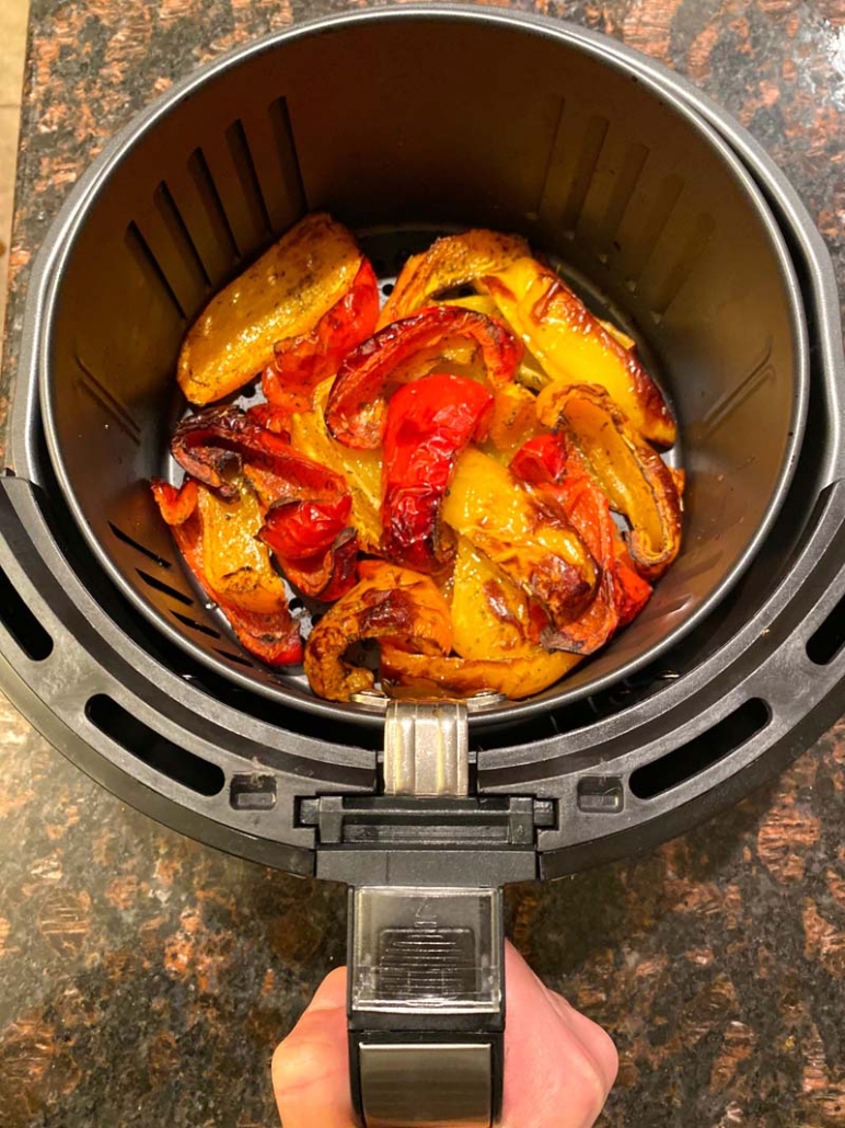 yellow, red and orange bell peppers in an air fryer basket