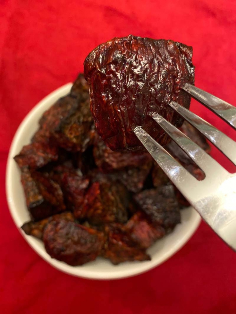 a piece of roasted beets on a silver fork