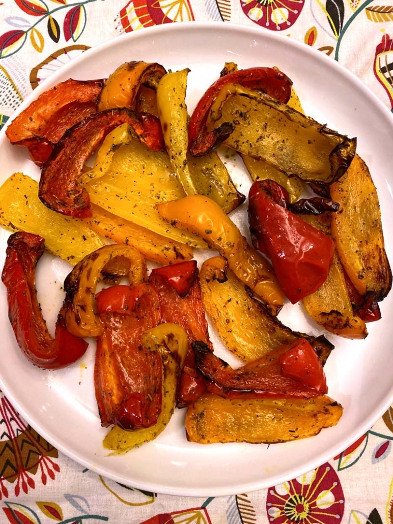 Roasted bell pepper pieces cooked in an air fryer on a white plate.