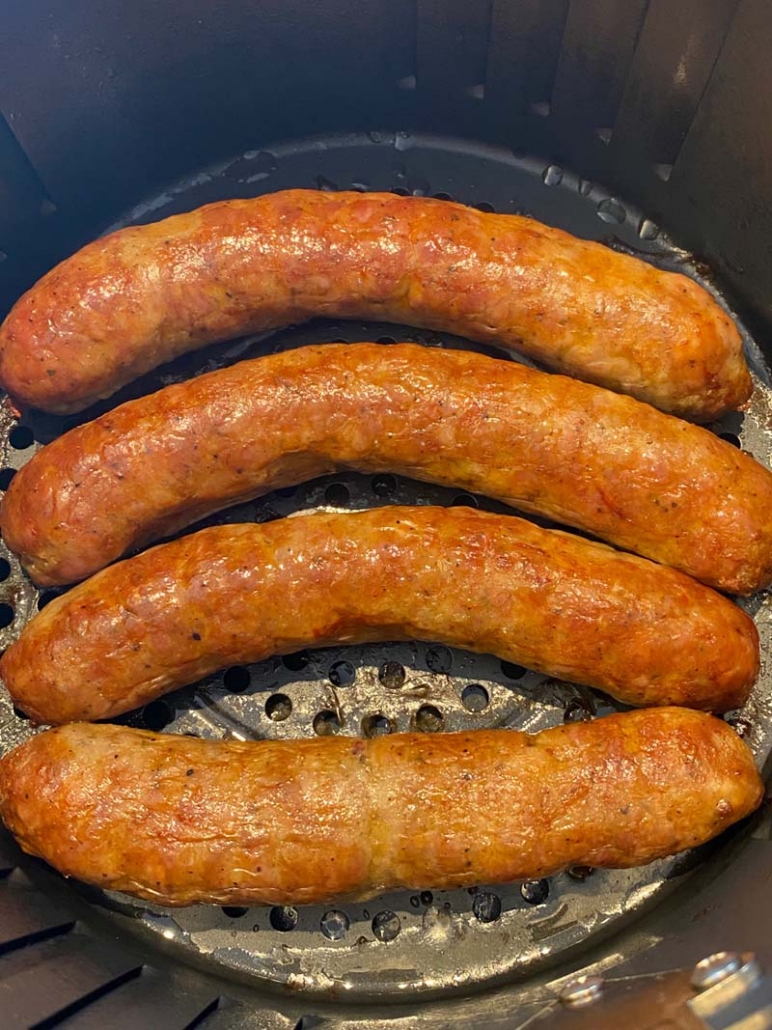fried italian sausages in an air fryer basket