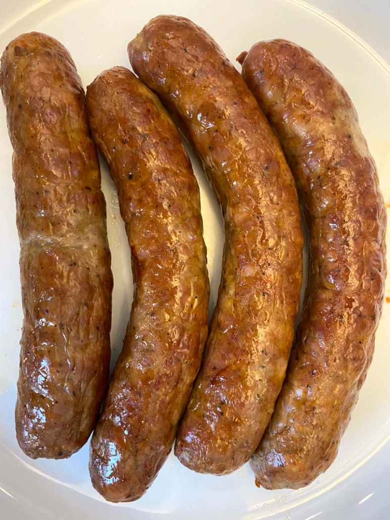 roasted italian sausages on a white plate