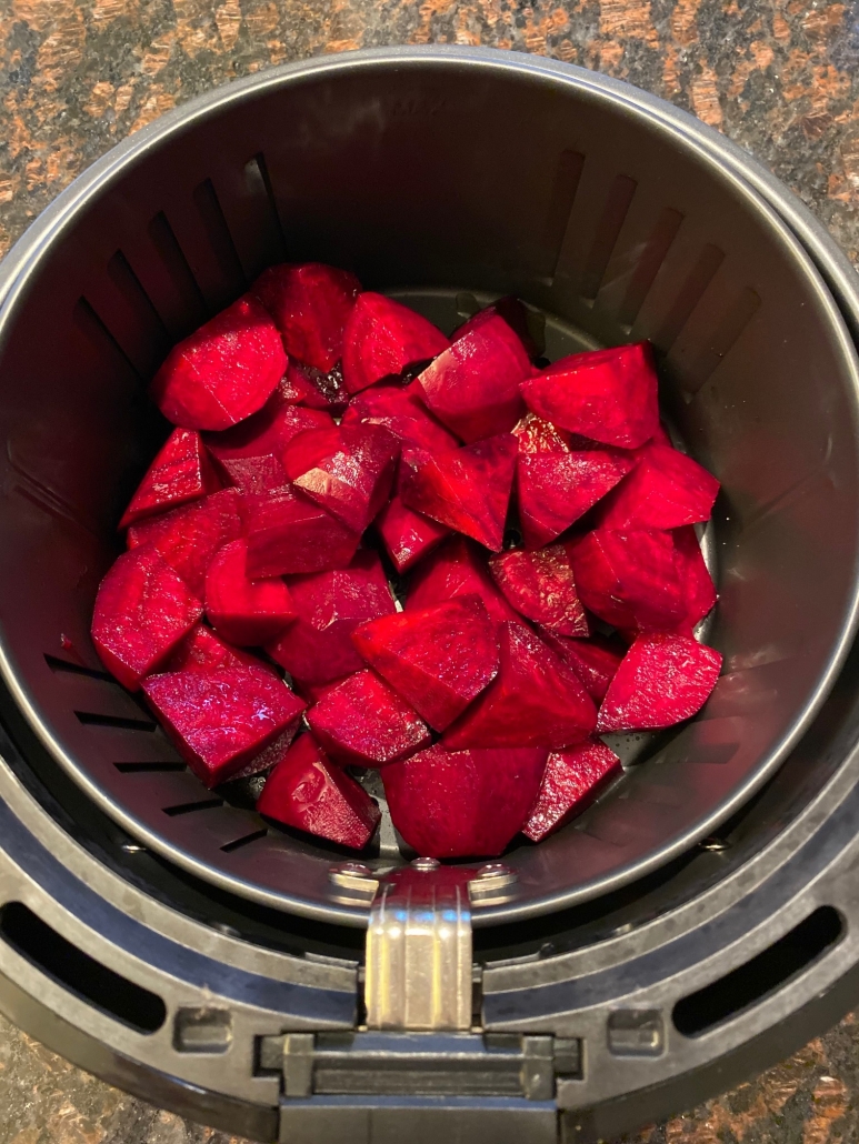 raw beets in an air fryer basket 