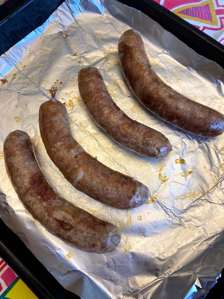 broiled italian sausages on a foiled sheet pan