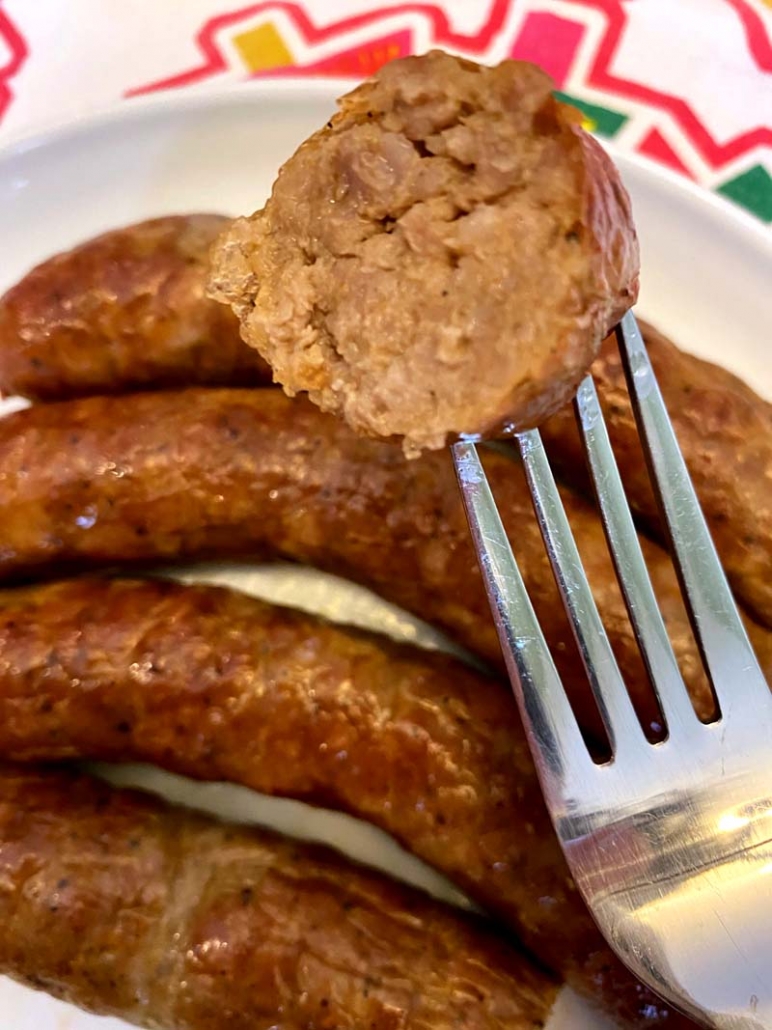 a bite of sausage on a fork